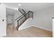 Inviting staircase with wood treads and modern black railings, blending style and functionality at 610 E Montebello Ave # 35, Phoenix, AZ 85012