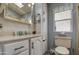 Clean bathroom featuring white cabinetry, marble countertop and a mirror at 7750 E Broadway Rd # 906, Mesa, AZ 85208