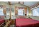 Comfortable bedroom with a red-striped bed, natural light, and side tables at 7750 E Broadway Rd # 906, Mesa, AZ 85208