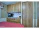 Bedroom featuring wood cabinets, a mounted TV, and a red bedspread at 7750 E Broadway Rd # 906, Mesa, AZ 85208
