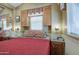 Cozy bedroom featuring a double bed, wood cabinets, and a window letting in natural light at 7750 E Broadway Rd # 906, Mesa, AZ 85208