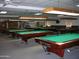 Spacious game room featuring multiple billiard tables with overhead lighting and neutral carpeting at 7750 E Broadway Rd # 906, Mesa, AZ 85208