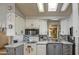 Bright and efficient kitchen with updated appliances, tiled backsplash, and functional layout at 7750 E Broadway Rd # 906, Mesa, AZ 85208