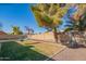 Grass lawn, trees, and a hanging chair in backyard at 7820 W Willow Ave, Peoria, AZ 85381