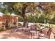 Desert landscaped backyard featuring a seating area with brown chairs and a trellis at 7844 E Coolidge St, Scottsdale, AZ 85251