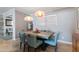 Dining room with stone-look tile floors, modern light fixtures, and stylish decor at 7844 E Coolidge St, Scottsdale, AZ 85251