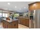 Open-concept kitchen with stainless steel appliances, granite countertops, and a center island at 7844 E Coolidge St, Scottsdale, AZ 85251