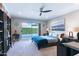 Bright main bedroom with ceiling fan and sliding door access to the pool at 7844 E Coolidge St, Scottsdale, AZ 85251