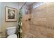 Bathroom shower with neutral tile and a pebble floor at 7844 E Coolidge St, Scottsdale, AZ 85251