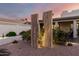 Backyard landscape featuring wood-like statues surrounded by desert landscaping, lighting, and a patio at 8708 E San Lucas Dr, Scottsdale, AZ 85258