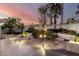 Landscaped backyard featuring desert plants, decorative stone, and paver patio under a colorful sky at 8708 E San Lucas Dr, Scottsdale, AZ 85258