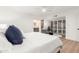 Cozy bedroom featuring a ceiling fan, large bed, and bathroom access at 8708 E San Lucas Dr, Scottsdale, AZ 85258