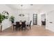 Elegant dining room with modern lighting, wood floors, and seating for six at 8708 E San Lucas Dr, Scottsdale, AZ 85258