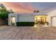 Beautiful home exterior with desert landscaping, a brick driveway, and a well-lit entrance at 8708 E San Lucas Dr, Scottsdale, AZ 85258