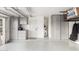 Well-organized garage featuring built-in storage cabinets, epoxy floors, and a door leading to the home at 8708 E San Lucas Dr, Scottsdale, AZ 85258