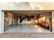 Spacious garage with epoxy flooring featuring storage cabinets, shelving and open access to the outdoors at 8708 E San Lucas Dr, Scottsdale, AZ 85258