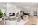 Open-concept living room with modern furnishings, fireplace, and seamless transition to the dining area at 8708 E San Lucas Dr, Scottsdale, AZ 85258