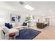 Cozy living room area flowing into a modern, eat-in kitchen with white cabinets and stainless steel appliances at 8708 E San Lucas Dr, Scottsdale, AZ 85258