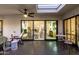 Covered patio with a ceiling fan, outdoor seating, access to the interior with sliding doors, and a skylight at 8708 E San Lucas Dr, Scottsdale, AZ 85258