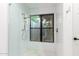 Modern tiled shower with a rain shower head and window at 8708 E San Lucas Dr, Scottsdale, AZ 85258