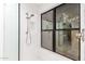 Modern tiled shower featuring a glass door, rainfall shower head, and large window at 8708 E San Lucas Dr, Scottsdale, AZ 85258