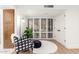 Cozy sitting area with modern decor, plush rug, and natural light filtering through shuttered windows at 8708 E San Lucas Dr, Scottsdale, AZ 85258
