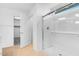 Bright bathroom featuring a glass-enclosed shower and a closet at 9036 S 196Th Dr, Goodyear, AZ 85338