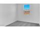 Bright bedroom with gray carpet, white walls, and a window showcasing the outside at 9036 S 196Th Dr, Goodyear, AZ 85338
