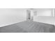 Spacious bedroom with soft carpet, white walls, recessed lights, and a view to the hallway at 9036 S 196Th Dr, Goodyear, AZ 85338