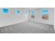 Bright bedroom featuring carpet, white walls, recessed lights, and three large windows with neighborhood views at 9036 S 196Th Dr, Goodyear, AZ 85338