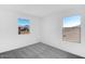 Bright bedroom with two windows and neutral carpeting at 9036 S 196Th Dr, Goodyear, AZ 85338