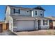 Charming two-story home featuring stone accents, neutral paint and an attached two-car garage with brick paver driveway at 9036 S 196Th Dr, Goodyear, AZ 85338