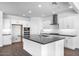 Bright kitchen with white cabinets, stainless steel appliances, an island, and recessed lighting at 9036 S 196Th Dr, Goodyear, AZ 85338