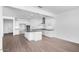 Spacious kitchen with white cabinets, stainless steel appliances, island, and wood floors at 9036 S 196Th Dr, Goodyear, AZ 85338