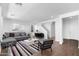 Inviting living room featuring a comfortable gray sectional sofa, modern art, and an accent chair at 9036 S 196Th Dr, Goodyear, AZ 85338