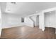 Bright open-concept living room featuring wood-look floors, white walls, and a staircase to the second story at 9036 S 196Th Dr, Goodyear, AZ 85338