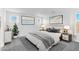 Well-lit bedroom with neutral tones, modern artwork, and side tables with lamps on either side of the bed at 9036 S 196Th Dr, Goodyear, AZ 85338