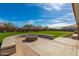 Landscaped backyard with fire pit and seating at 11682 W Parkway Ln, Avondale, AZ 85323