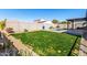 Spacious backyard with grassy lawn, pool, and patio at 11682 W Parkway Ln, Avondale, AZ 85323