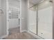Modern bathroom with a large glass shower and built-in shelving at 11682 W Parkway Ln, Avondale, AZ 85323
