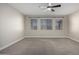 Well-lit bedroom with three windows and ceiling fan at 11682 W Parkway Ln, Avondale, AZ 85323