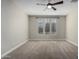 Bright bedroom with three windows and ceiling fan at 11682 W Parkway Ln, Avondale, AZ 85323