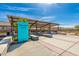 Covered outdoor gathering space with picnic tables and grills at 11682 W Parkway Ln, Avondale, AZ 85323