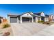 Modern home with gray two-car garage and brick facade at 11682 W Parkway Ln, Avondale, AZ 85323