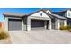 Modern home with gray two-car garage and brick facade at 11682 W Parkway Ln, Avondale, AZ 85323