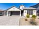 Modern two-story home with a brick facade and a two-car garage at 11682 W Parkway Ln, Avondale, AZ 85323