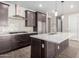 Stylish kitchen with dark cabinets, quartz countertops and stainless steel appliances at 11682 W Parkway Ln, Avondale, AZ 85323