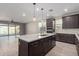 Open concept kitchen with an island and stainless steel appliances at 11682 W Parkway Ln, Avondale, AZ 85323