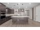 Modern kitchen with dark cabinetry, quartz countertops, and island at 11682 W Parkway Ln, Avondale, AZ 85323