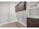 Bright laundry room with modern cabinetry and tile floors at 11682 W Parkway Ln, Avondale, AZ 85323
